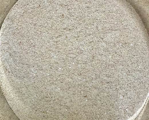 Close-up texture of powdered nectar mix in a shallow round dish