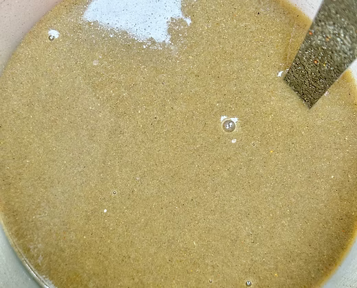 Prepared liquid nectar mixture inside a bowl on a cage surface