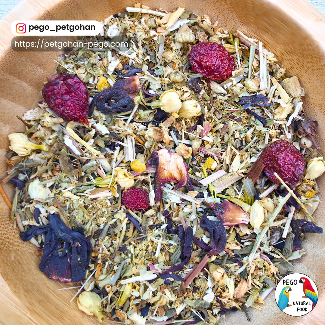 Close-up of Vigilan-Tea in a wooden bowl, showing dried rose hips, chamomile and jasmine blossoms, tulsi, elderberry, echinacea, peppermint, ginger root, lemon peel, oregano, yarrow, and decaffeinated green tea.